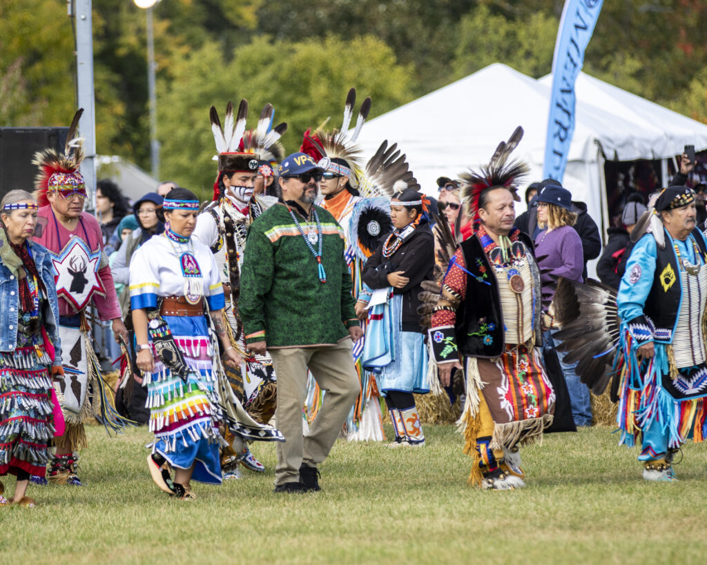 Dancers entering the circle at the American Indian Center Chicago Powwow in 2022