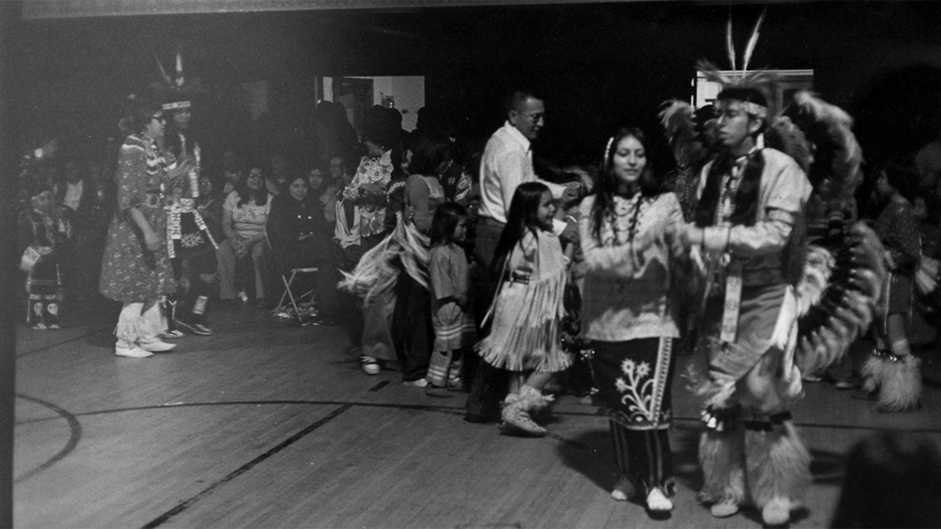 Black-and-white photograph of dancers at an early American Indian Center powwow in Chicago